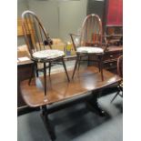 An Ercol dining table and four chairs