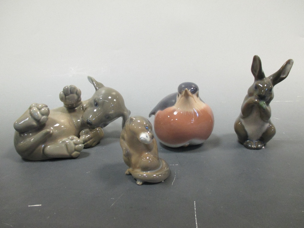 A Royal Copenhagen figure of a Puppy, a Robin, a Rabbit and an Otter (4)