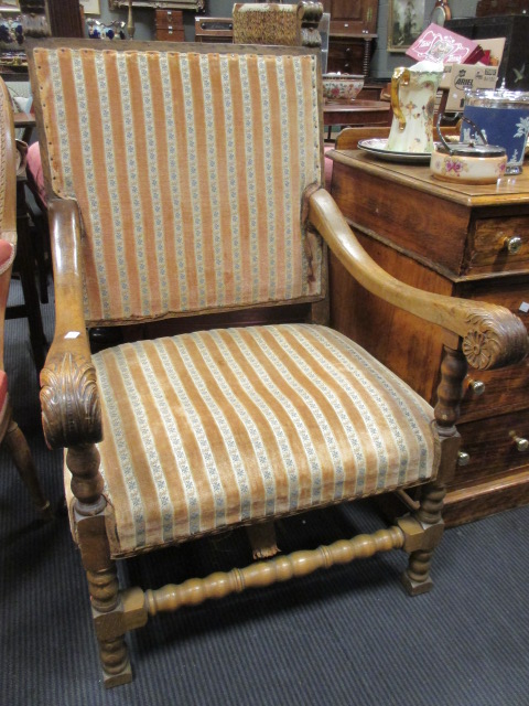 A 17th century style walnut framed elbow chair with replacement legs and stretchers