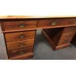 A late Victorian walnut pedestal desk with brass recessed handles, 81cm high x 141cm w x 74cm deep