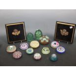 Thirteen glass paperweights and a pair of plaques