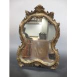 A mahogany toilet mirror with arched plate, another in the 18th century style and a rococo gilt