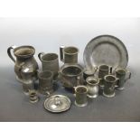 A collection of pewter mugs and other pewter wares