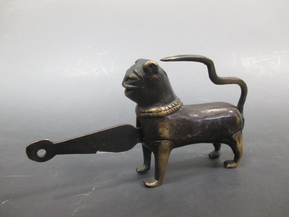 An ancient Persian style bronze padlock in the form of a lion with its key