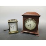 An Edwardian Sheraton revival mantle clock; and a brass carriage clock retailed by Harrods (2)
