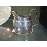 A George III cream jug with bright cut decoration