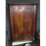 A George III mahogany corner cupboard, 87cm wide