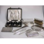 A cased set of silver coffee spoons, table cigarette box, cigarette case, silver backed mirror,