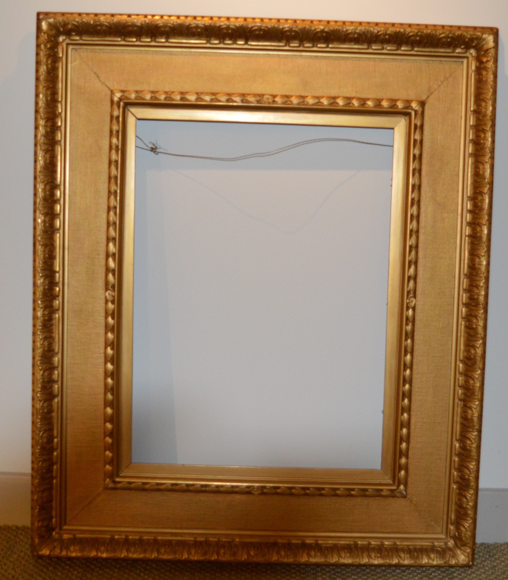 A gilded 19th Century plaster frame with inset floral corners, some chips, 73 x 57 cm sight size;