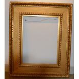 A gilded 19th Century plaster frame with inset floral corners, some chips, 73 x 57 cm sight size;