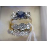 A three stone sapphire and diamond ring, estimated weight of diamonds approx. 0.4cts, indistinctly