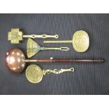 Four brass skimmers and a copper warming pan