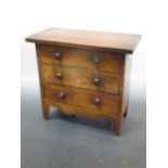 A George IV mahogany apprentice chest of drawers, on bracket feet together with a part 19th