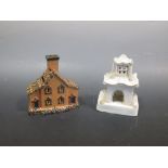 A Staffordshire pastille burner and a money box in the form of houses (2)