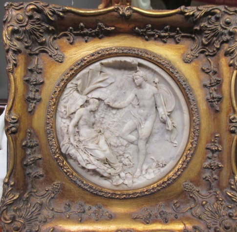 A round imitation marble reliefi plaque in gilt frame