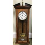 A 19th century walnut Vienna wall clock, the broken pediment with brass finial above typical
