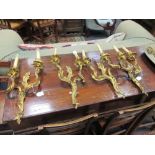 A set of four gilt cast brass and gilt two branch wall lights (4)