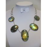 A labradorite necklace, the five oval cabochons in collet mounts, largest 5cm long, and