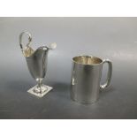 A silver helmet shaped cream jug together with a silver 'Ovaltine' half pint mug