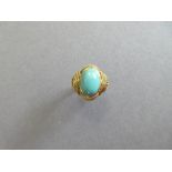 An Italian single stone dress ring, set with an oval cabochon turquoise simulant stone collet set in