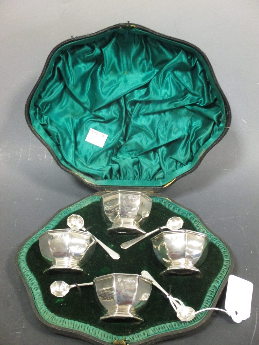 A set of four silver octagonal salts and spoons, London 1897, in shaped fitted case