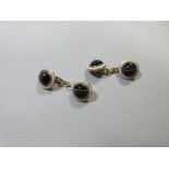 A pair of banded agate and enamel cufflinks, each double ended piece a round cabochon banded agate