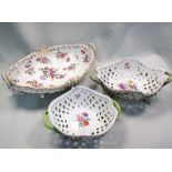 Two Meissen porcelain pierced two handled baskets, of lozenge shaped form with wavy rims, painted