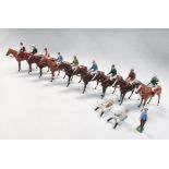 A collection of nine Britains horses, eleven jockeys and a groom, the bay and chestnut horse saddled