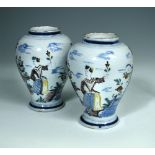 A pair of 18th century Dutch Delft polychrome vases, of shouldered ovoid form, decorated with a lady