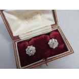 A pair of diamond cluster earrings cased by Garrard, each earstud designed as a flowerhead