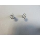 A pair of single stone marquise cut diamond earstuds, each post headed by a diaper form cushion