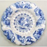 An 18th century Frankfurt Delft blue and white dish, the central boss roundel painted with a Chinese