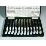A set of six pairs of Edwardian Meissen style handled fruit knives and forks, the silver blades