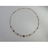 A graduated multi-colour sapphire necklace, each oval or round cut stone spectacle set and joined by