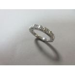 A princess cut diamond and platinum half hoop eternity ring, the nine uniform square cut diamonds