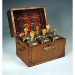 A 19th century mahogany decanter box with six gilt glass decanters, the front with shell and