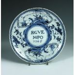 An 18th century Dutch delft blue and white dated plate, the centre inscribed 'RGVE MPO 1745', the