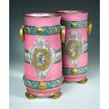 A pair of 19th century French opaque glass two handled vases, the pink ground bodies reserved with