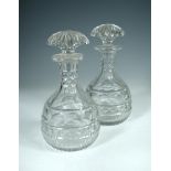 A pair of Anglo-Irish magnum decanters and stoppers, the large mushroom shaped stoppers star cut,