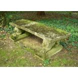 A composite stone low curved bench on lion supports, 47 x 233 x 53cm (18 x 91 x 21in)