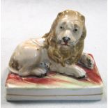 An early 19th century pottery lion by Wood & Caldwell, circa 1820, the recumbent lion resting on a