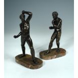 After the Antique, a pair of early 19th century bronze athletes, each mounted to an oval mottled