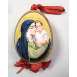 A Russian porcelain egg painted with the Virgin and Child, the oval on one side, the gold ground