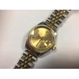 Rolex - a lady's stainless steel, Oyster Perpetual Date wristwatch, with gold coloured bezel, the