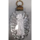 An 1820s Baccarat sulphide of Christ holding the cross, the clear glass oval star cut on the