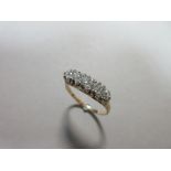 A diamond five stone ring with further diamond highlights, the five graduated round brilliant cut