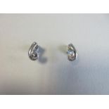 A pair of modern designer-made single stone diamond earstuds, each fancy 'spirit sun' round cut