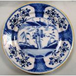 A pair of 18th century Delft blue and white plates, decorated to the centres with landscapes with