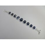 A chunky sapphire bracelet, the articulated and graduated line of nine fancy oval cut sapphires