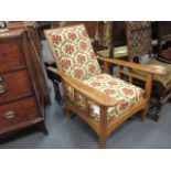An oak upholstered arm chair with adjustable back